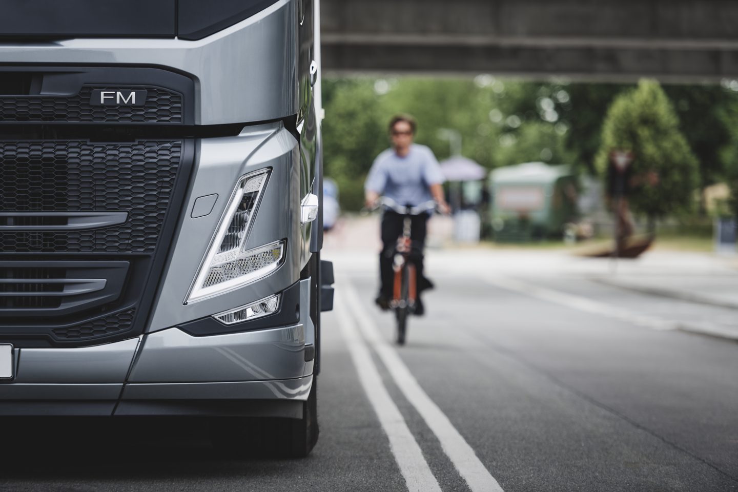Pedestrian crossing road. Volvo FM in the back
